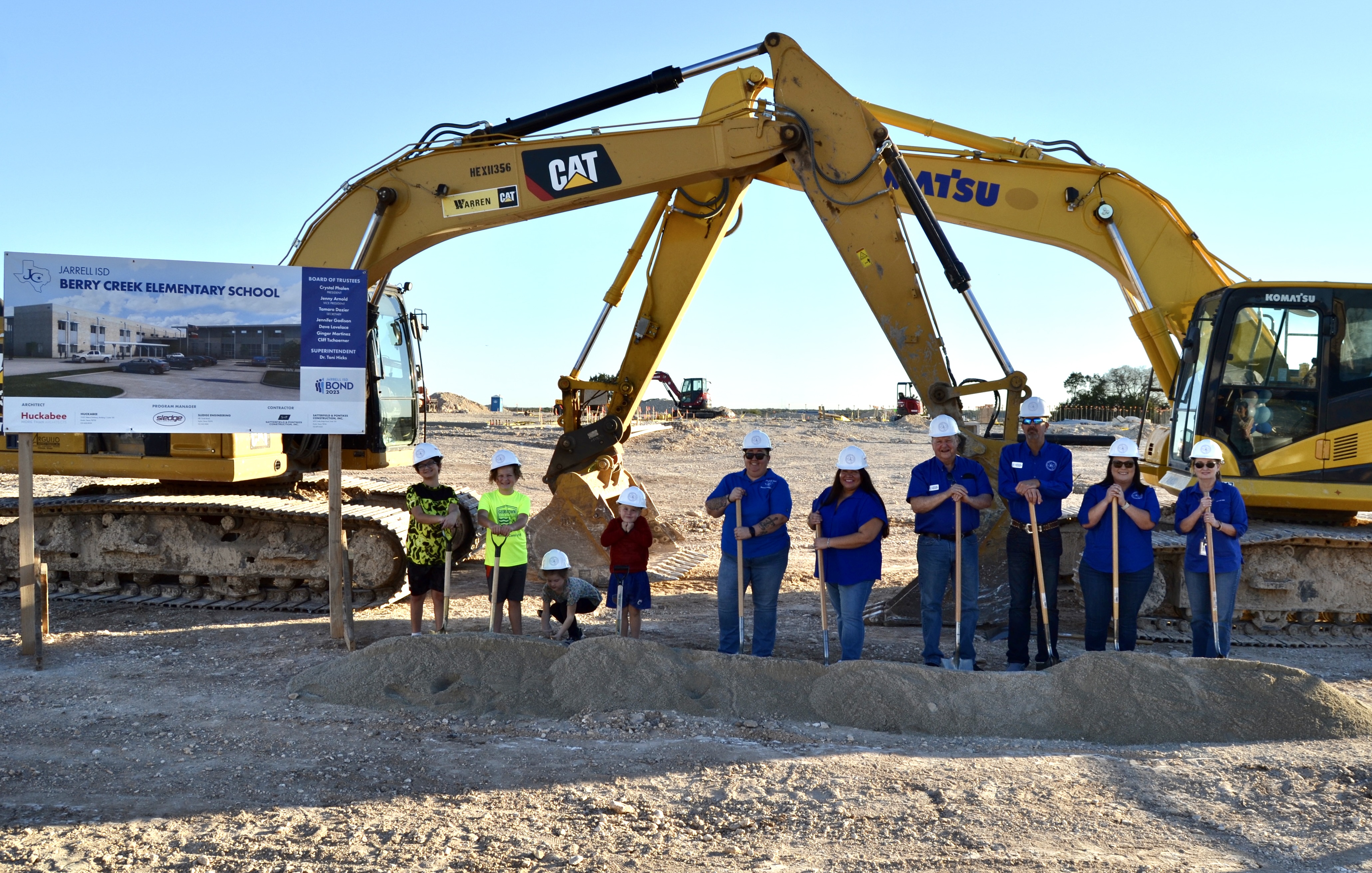 group photo of people at a construction site.